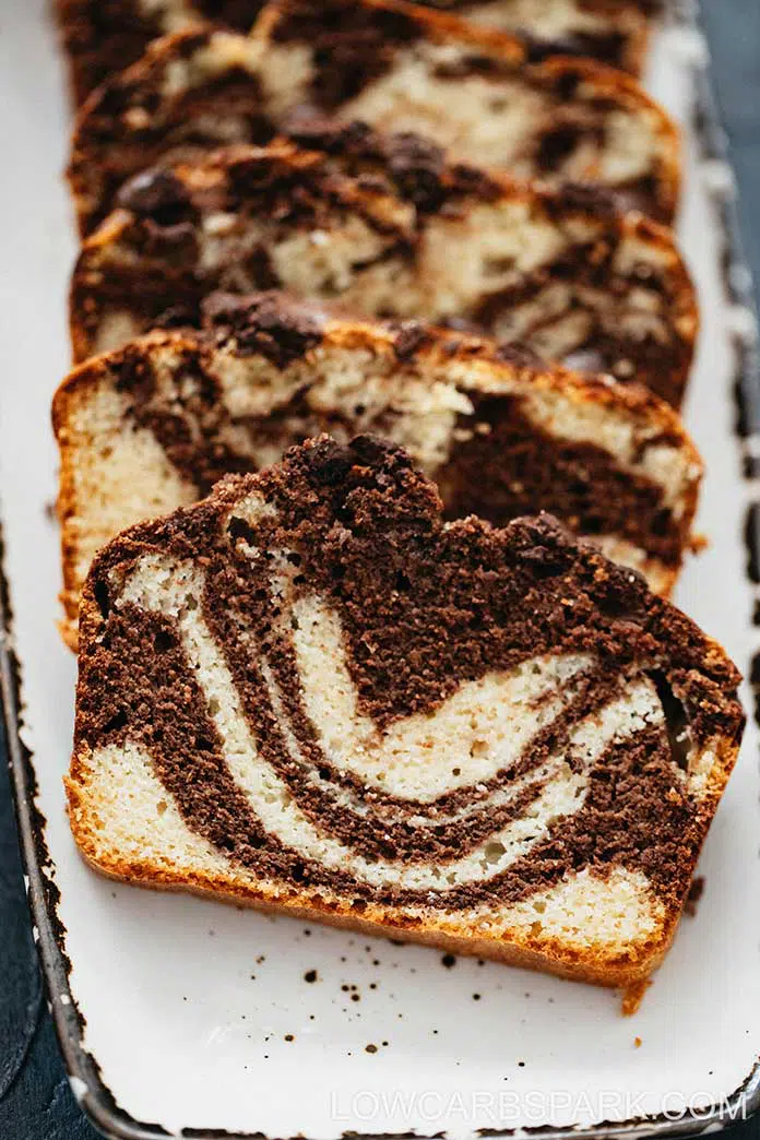 Slices of chocolate marble cake on a white surface.