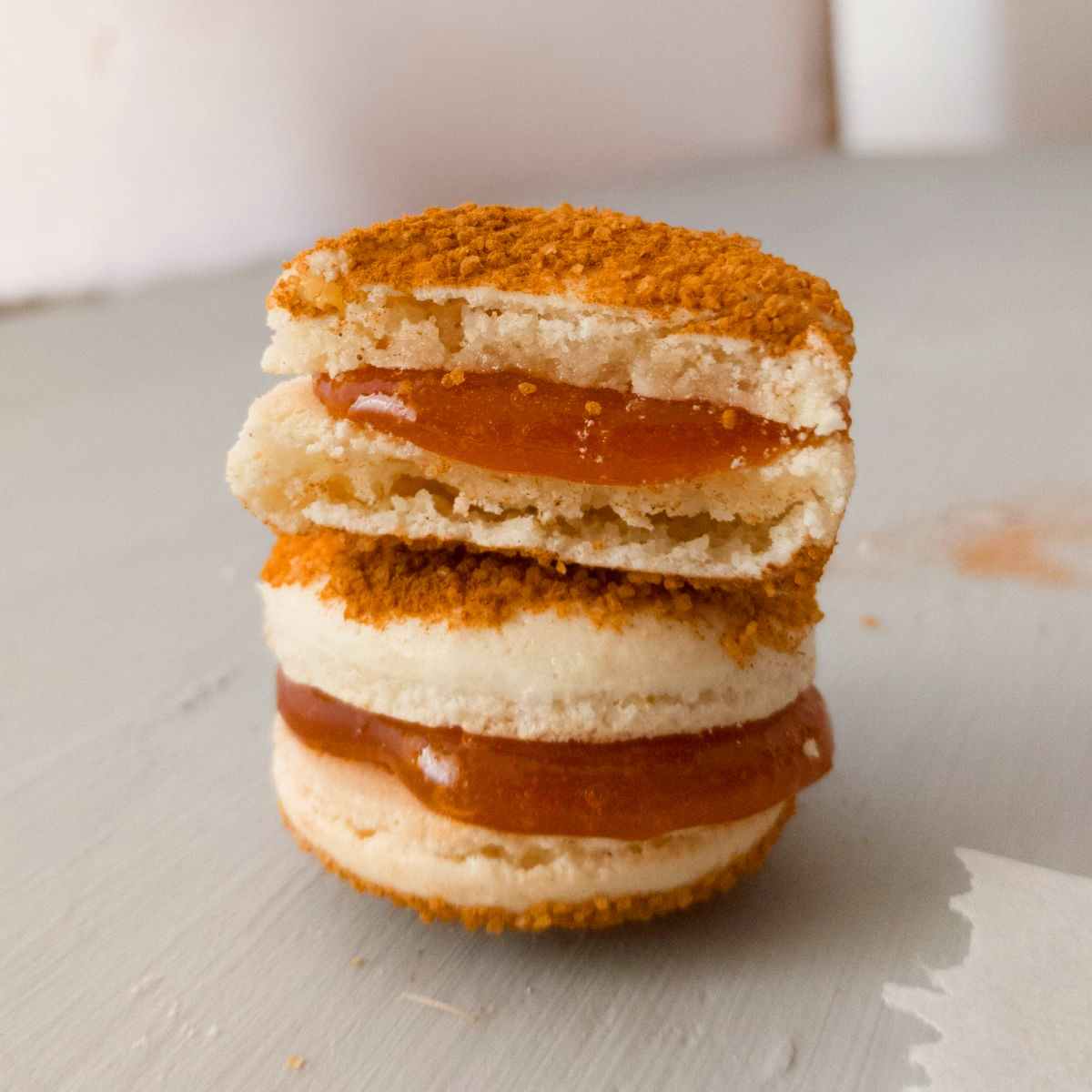 Two churro macarons stacked on top of each other.