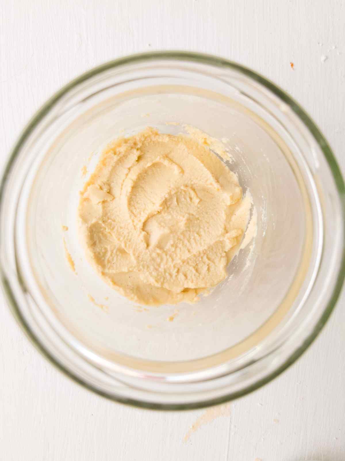 Sourdough starter on the bottom of a glass jar from above.