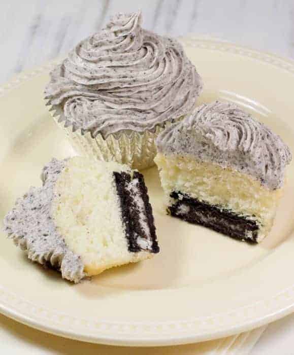 Cupcakes made with gluten-free cake mix on a plate, one is sliced in half.