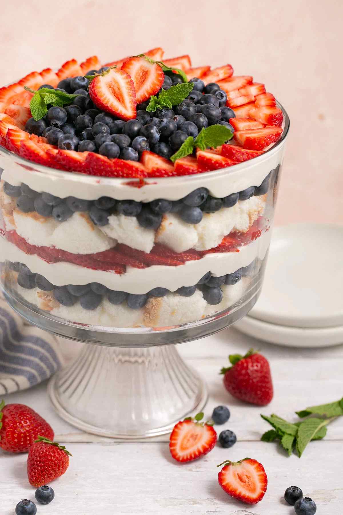 A glass with a trifle strawberry cake.