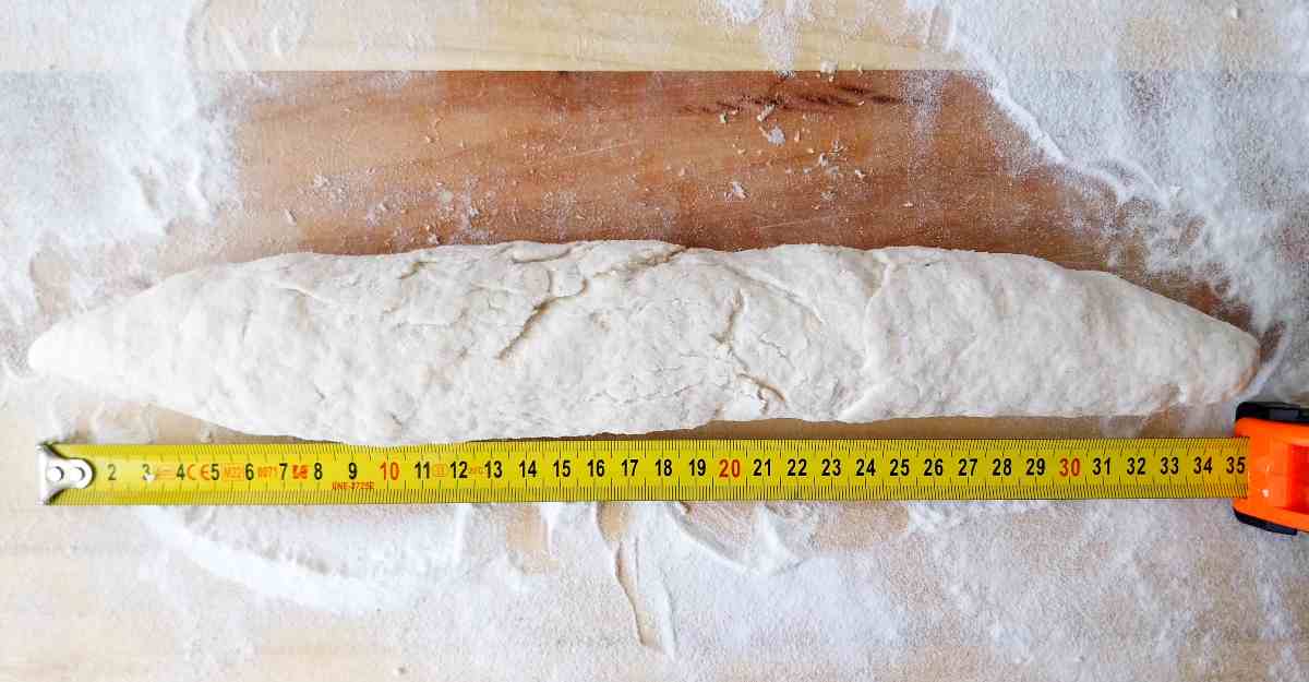 Measuring tape against a baguette.