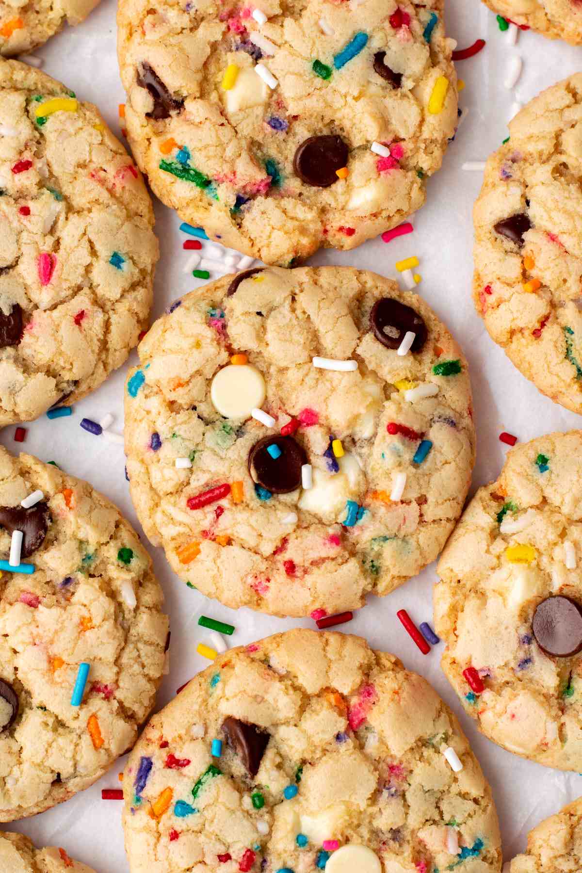 Funfetti cookies up close on a white surface.