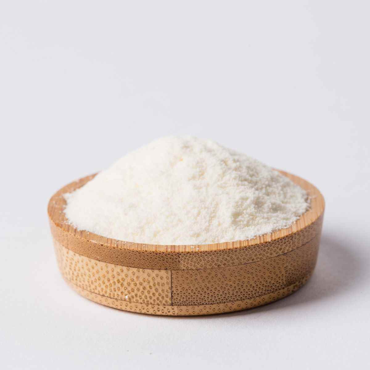 Konjac powder in a wooden bowl on a white background.