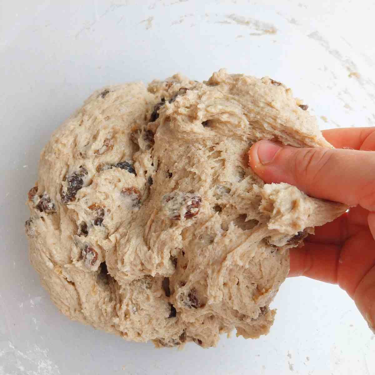 Mixed dough in a glass bowl.