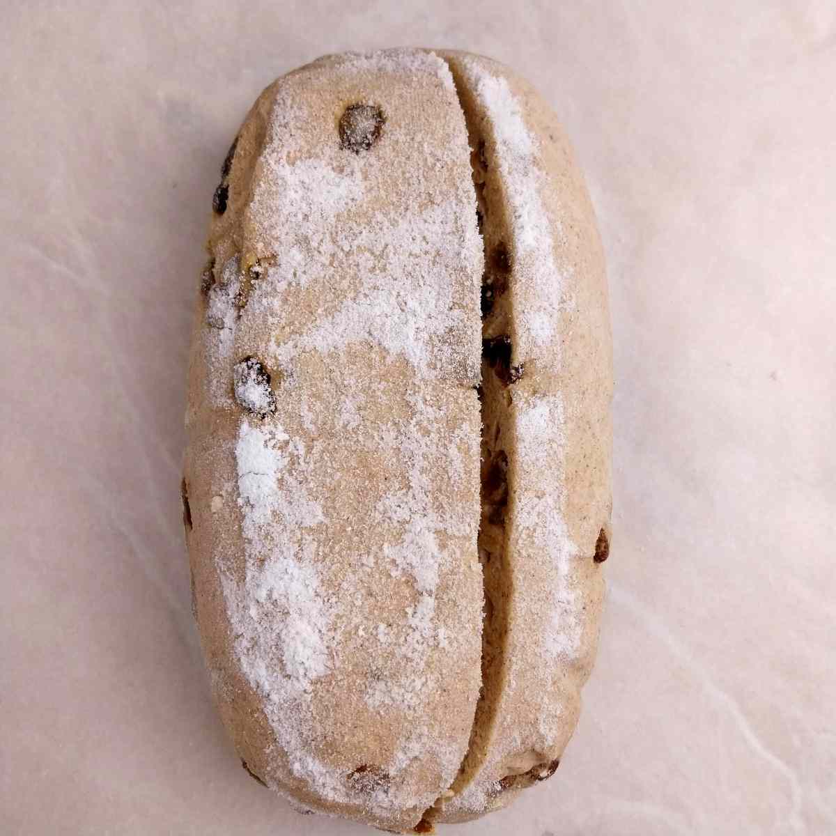 The scored dough on a piece of parchment paper.