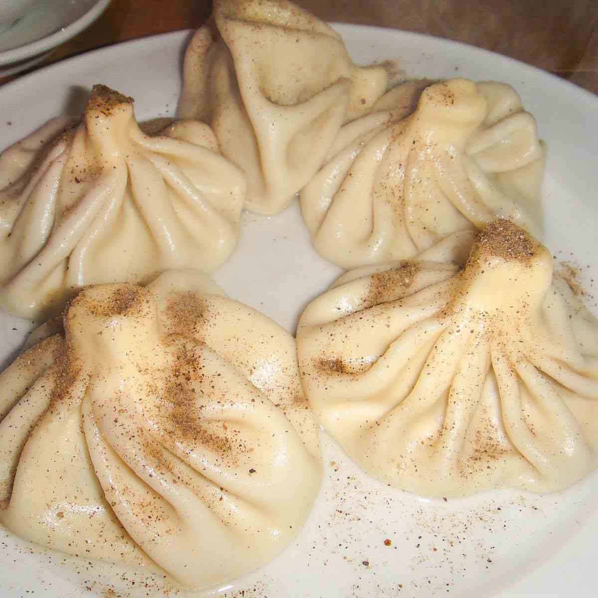 Khinkali on a white plate.