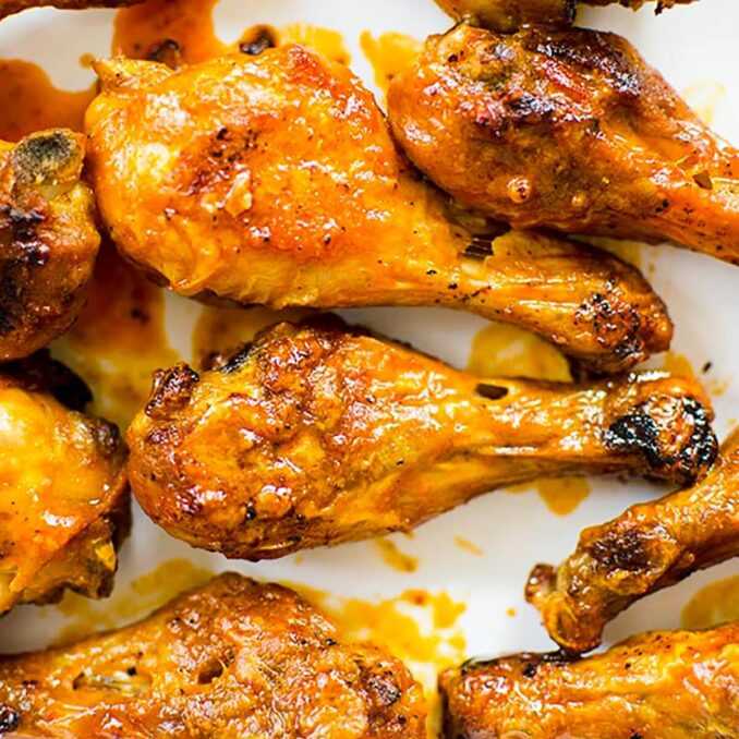 Chicken drumsticks on a white background.