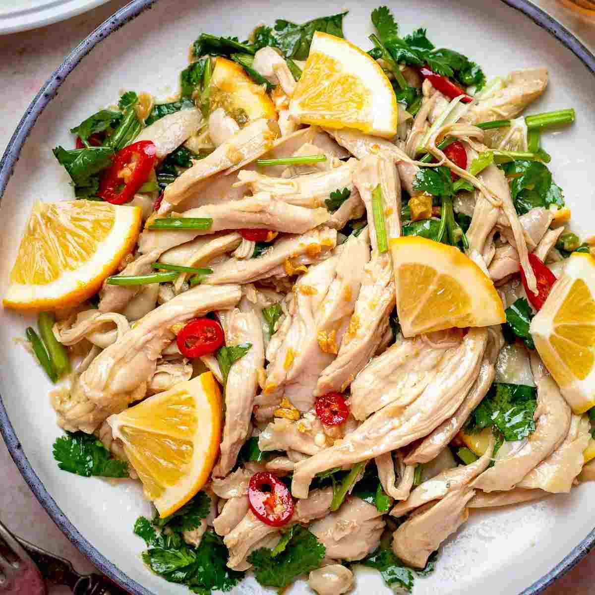 Chinese chicken salad on a white plate up close.