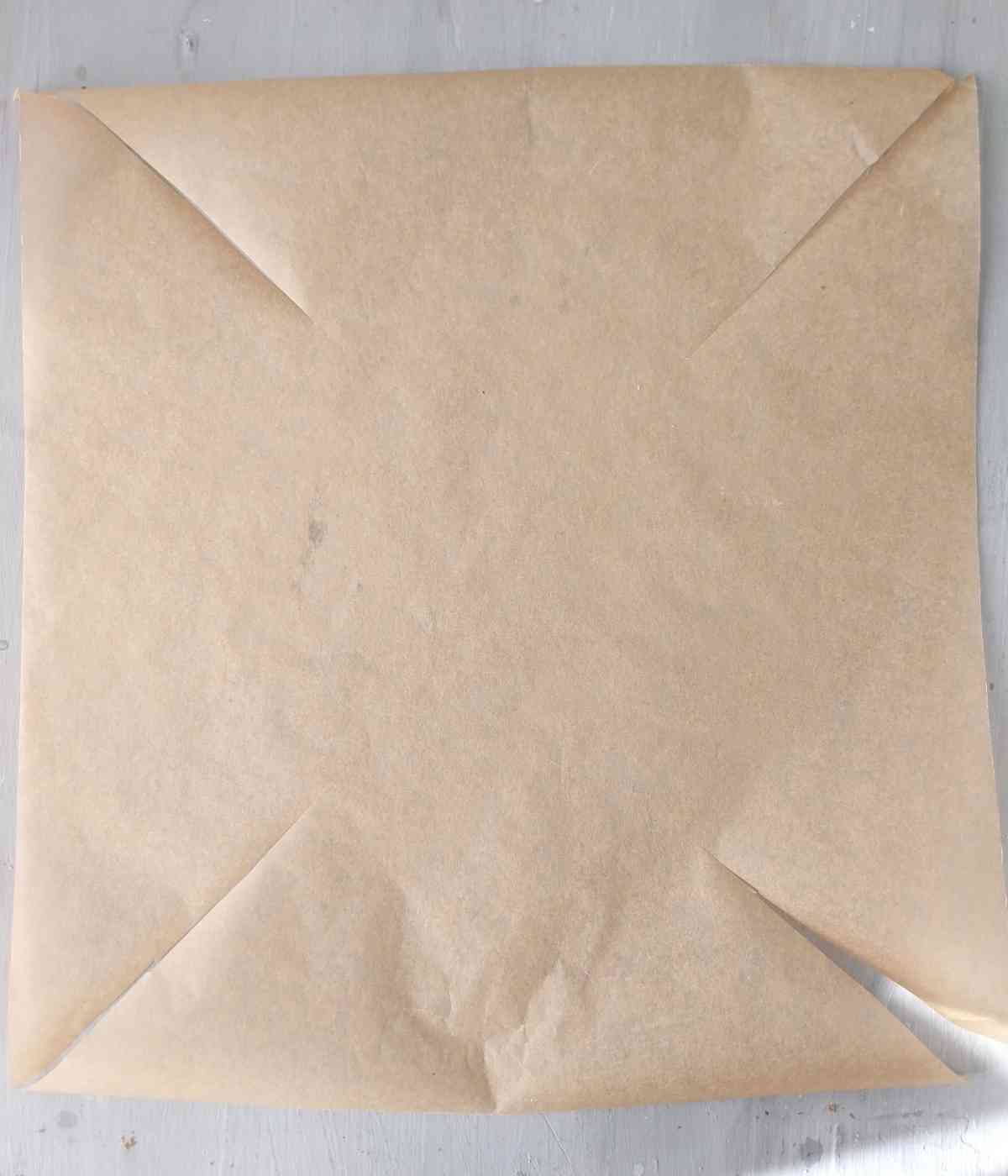 The piece of parchment paper cut on the corners.