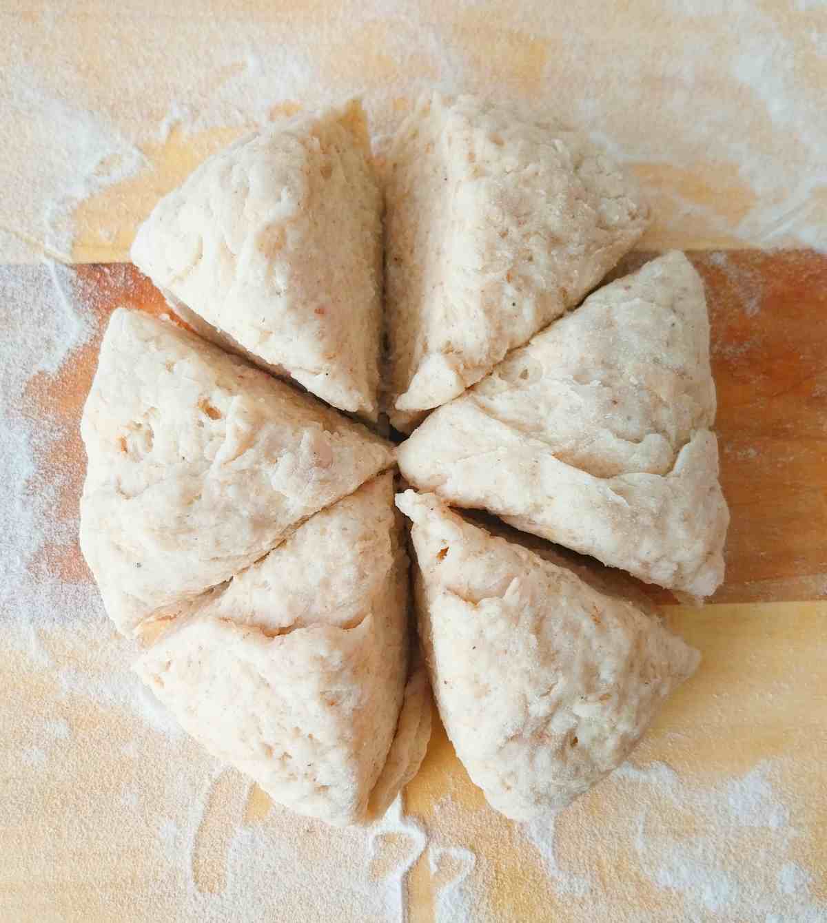 The dough ball divided using a bench scraper into six equal pieces. 