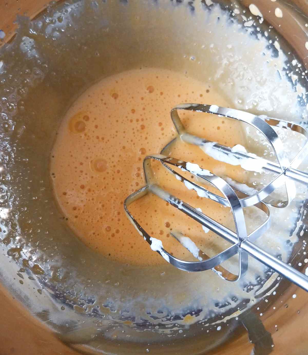 Whipped egg yolks in a metal bowl.