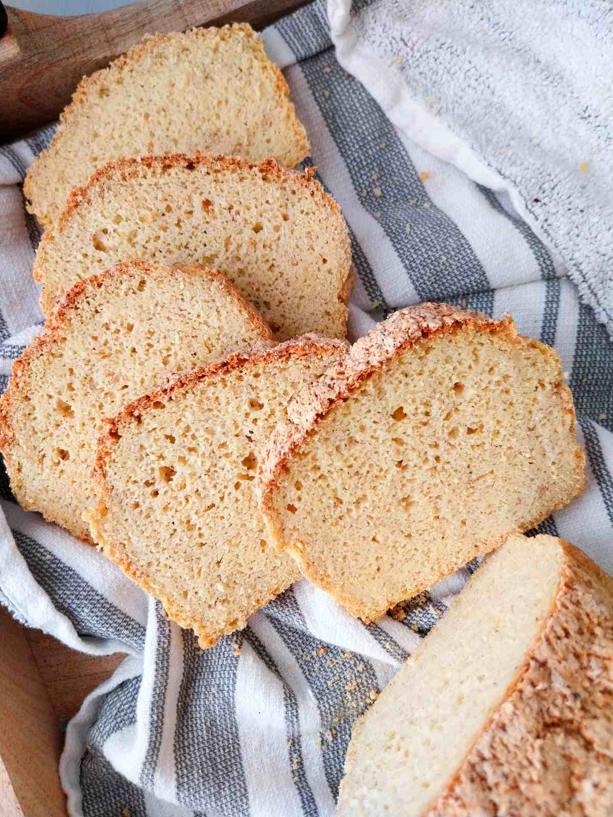 Millet bread sliced and arranged on a kitchen towel.