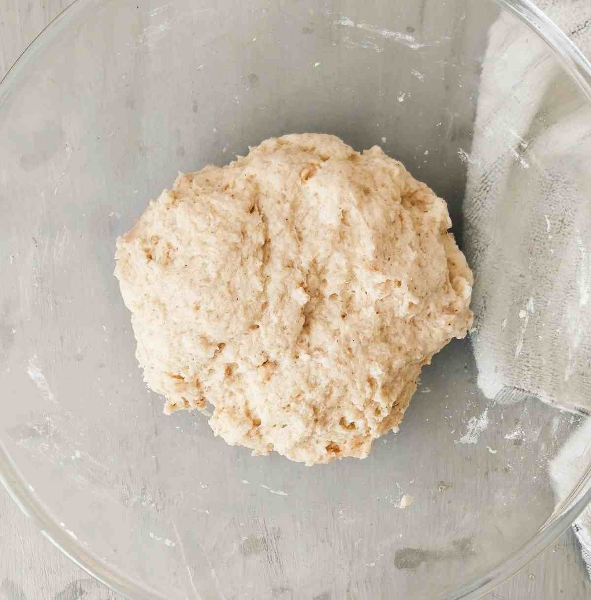 Lebanese bread dough that rose in a glass mixing bowl.