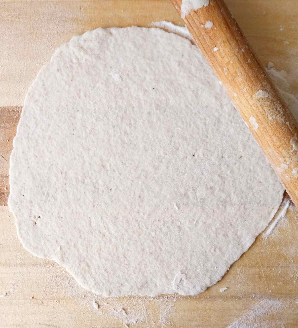 Rolled out lavash with the rolling pin on the side.