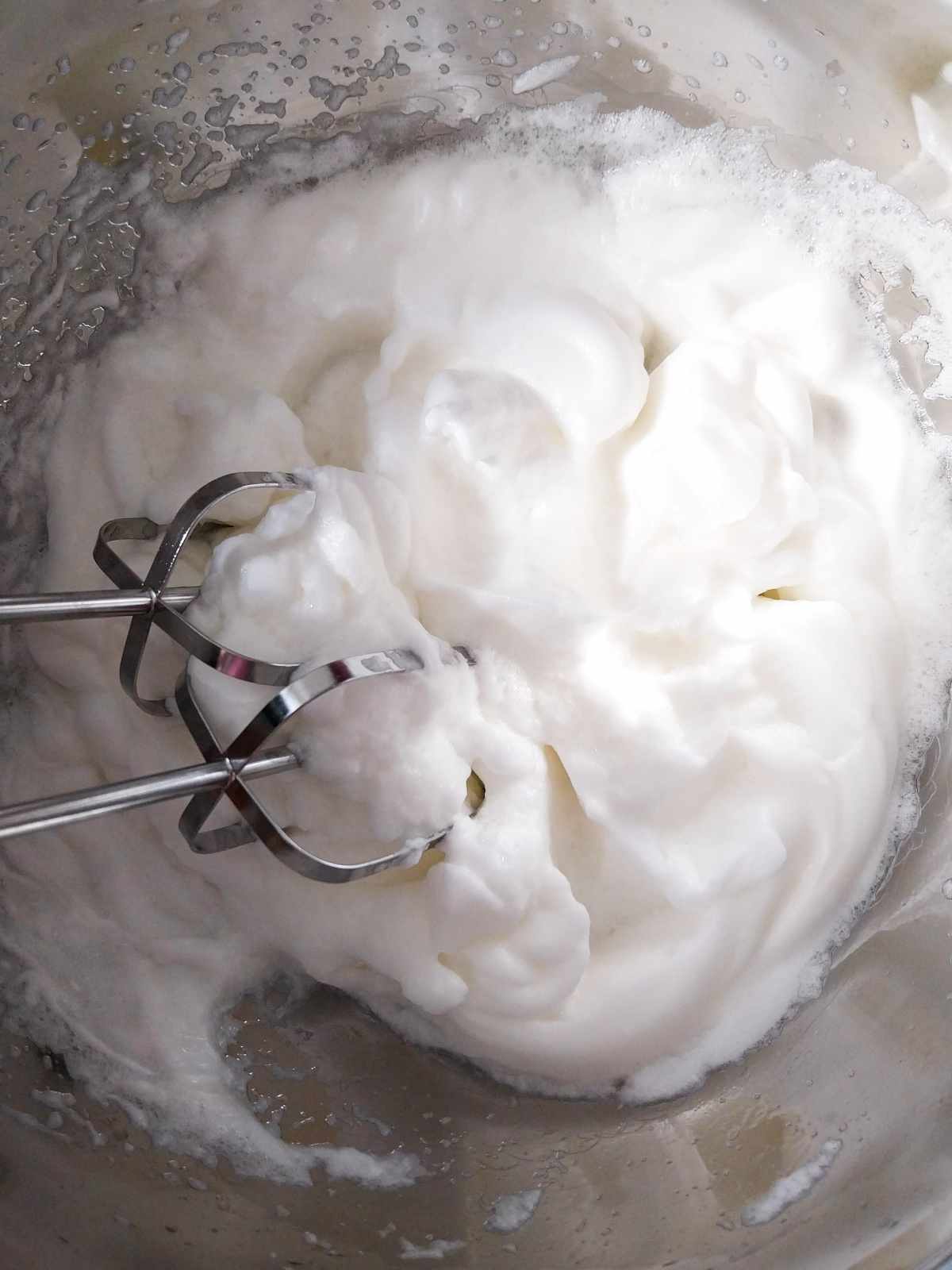 Egg whites whipped until they have stiff peaks.