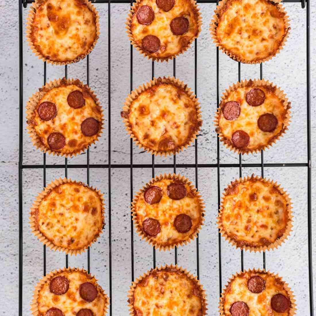 Cauliflower pizza bites on a cooling rack. 