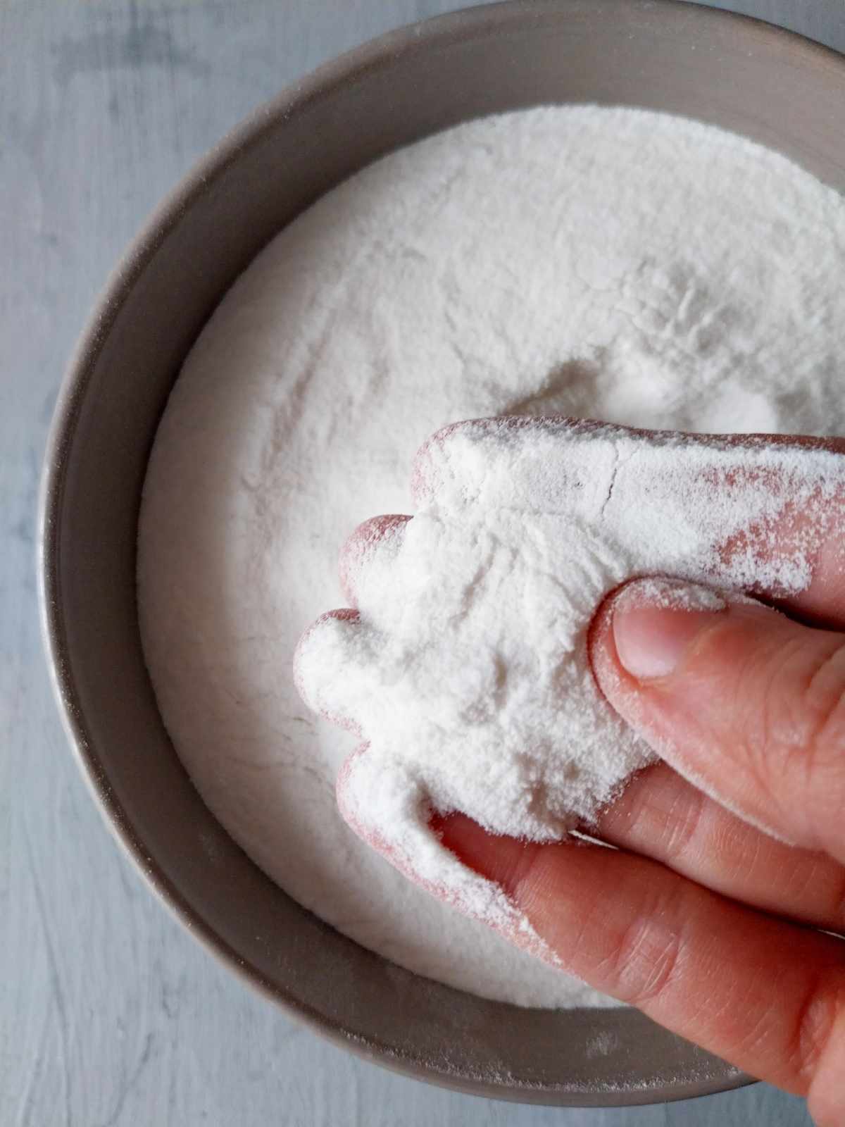 Rice flour held in a hand.
