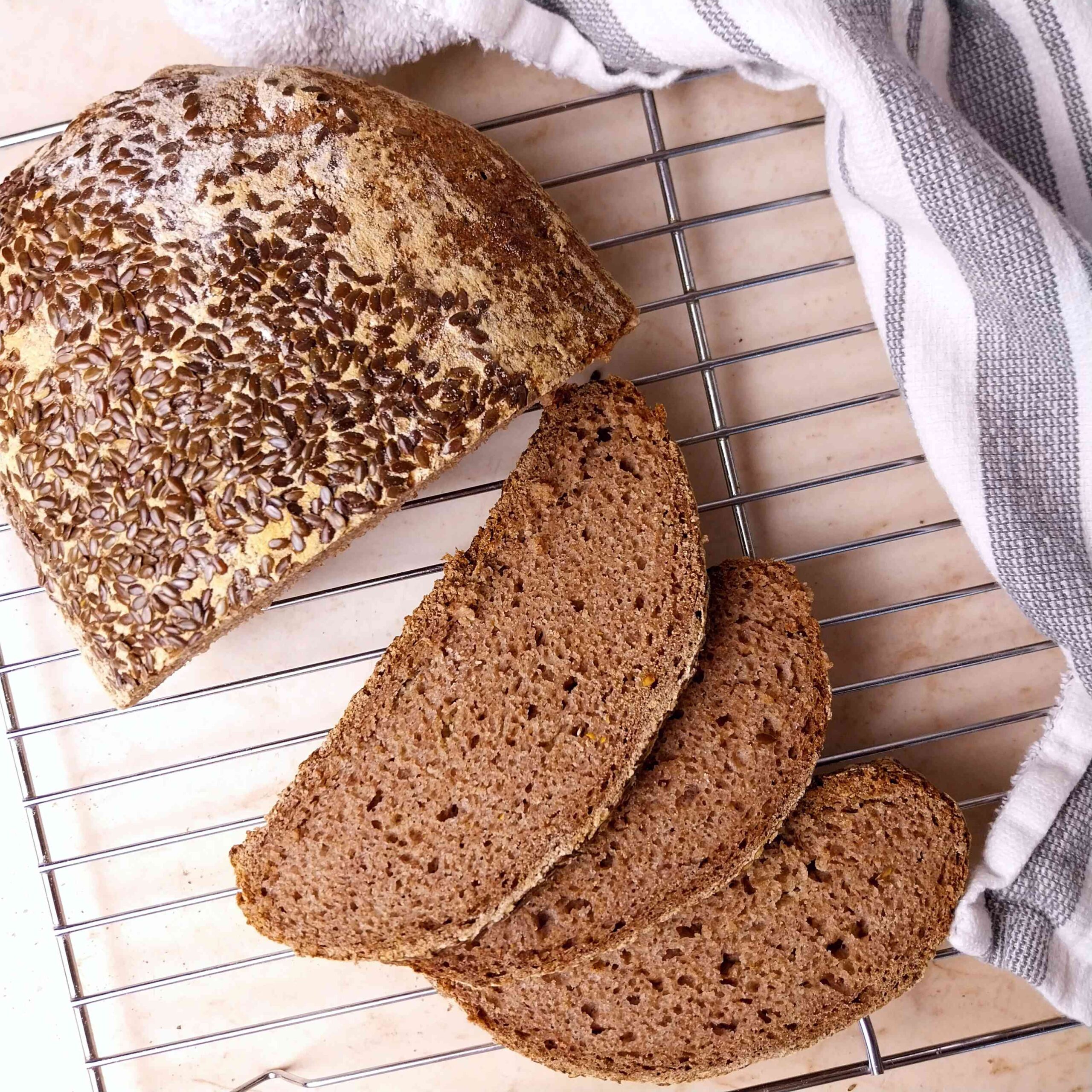 Sliced gluten-free teff bread on a cooling rack.