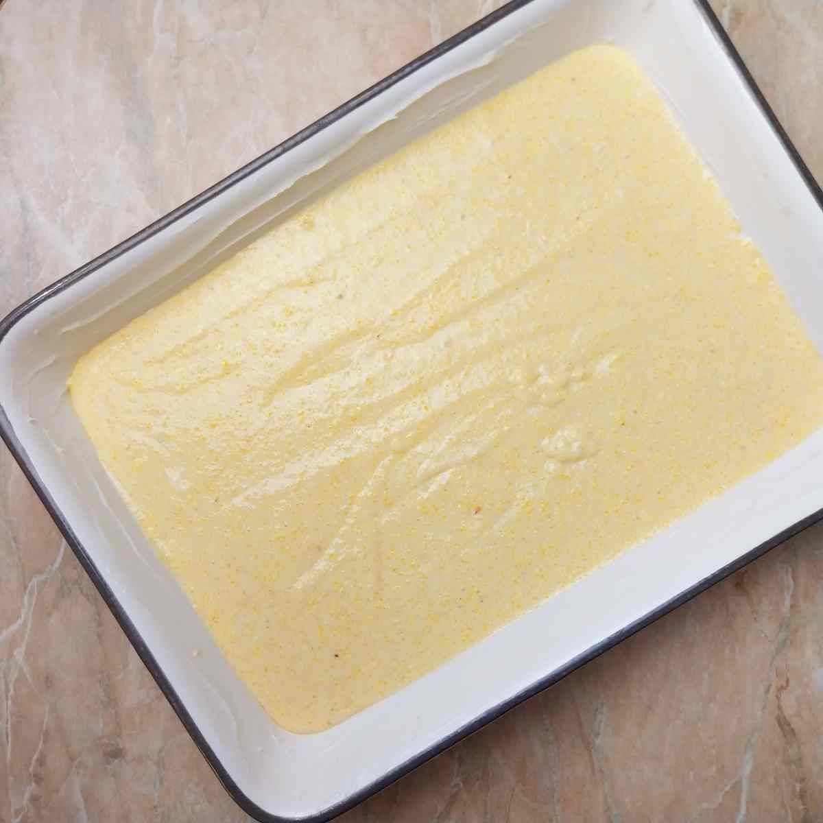Unbaked cornbread dough in the baking dish.
