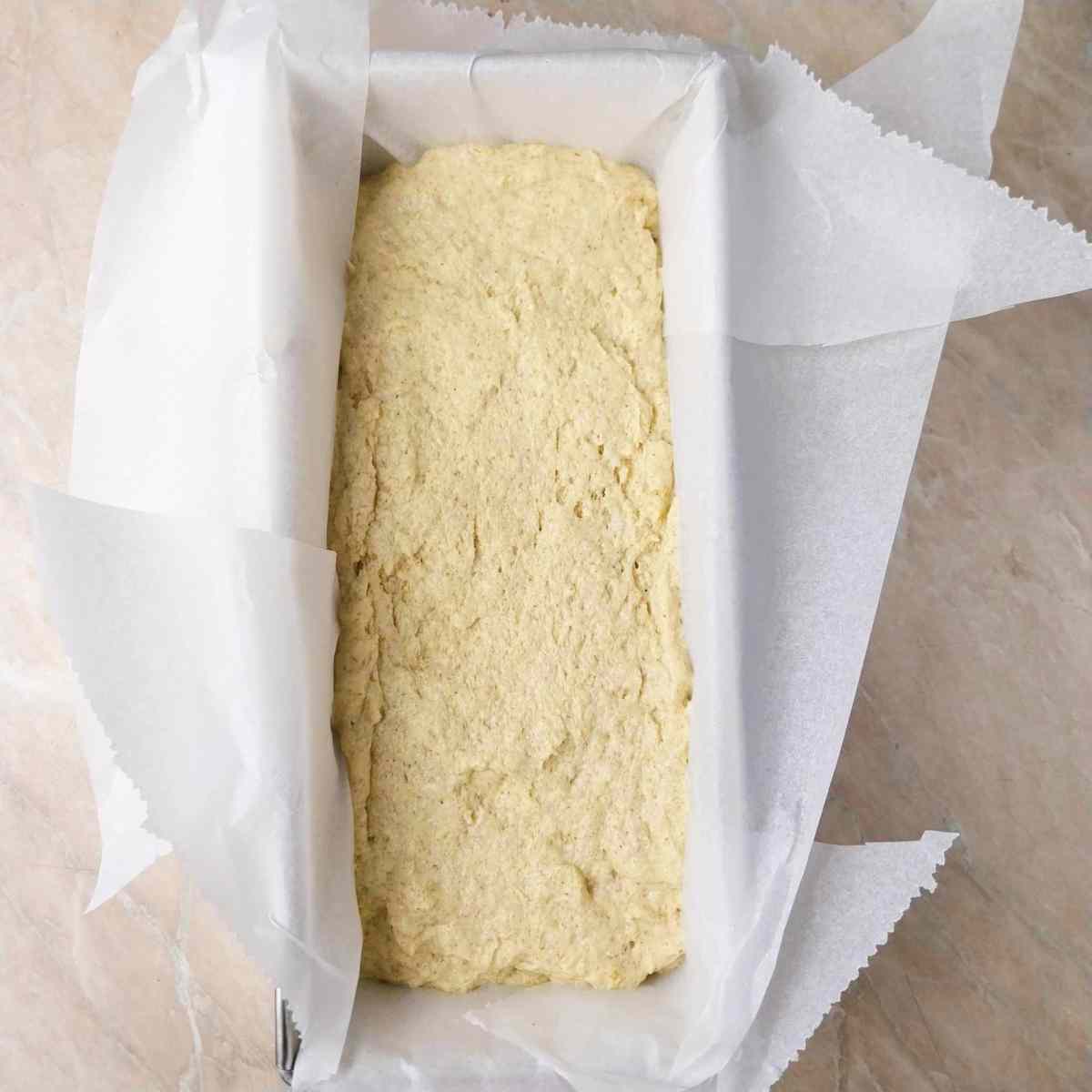 Millet dough in a lined baking bread pan.