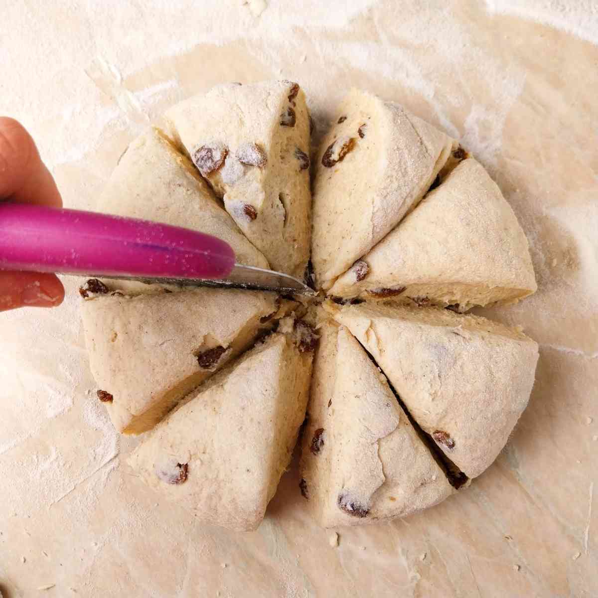 Dividing the dough into eight parts with a bench scraper.