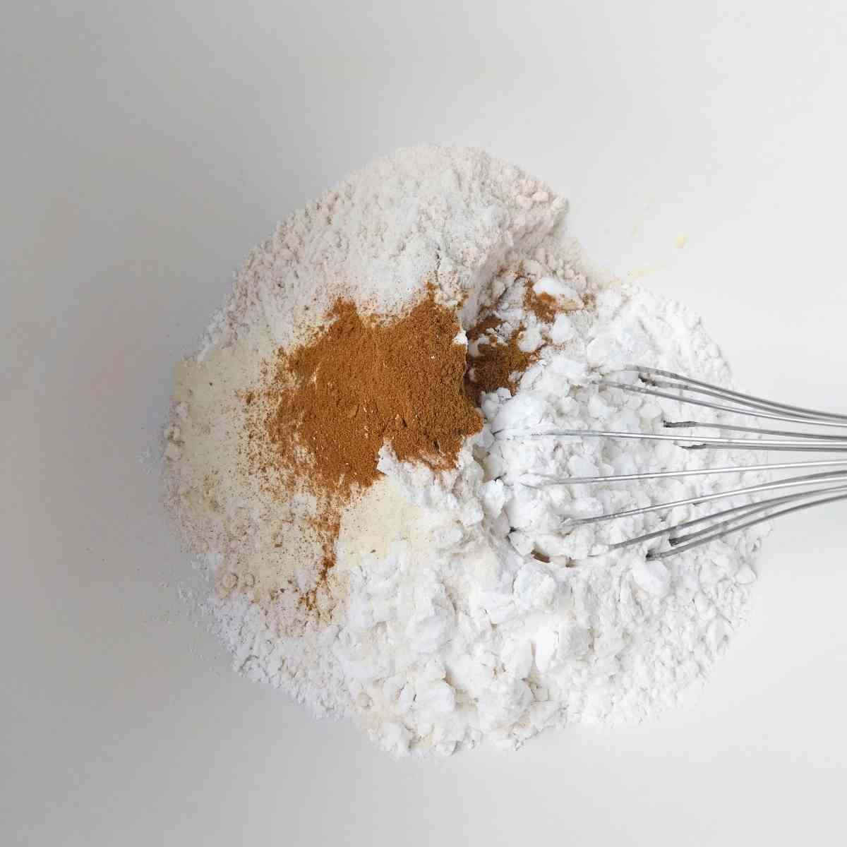 Dry ingredients in a large mixing bowl with a whisk.