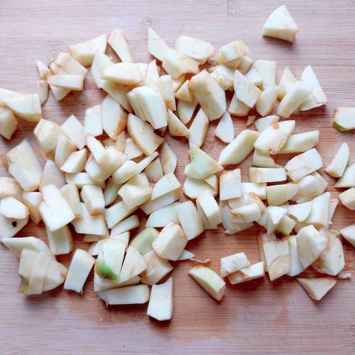 Chopped apples on a wooden board.
