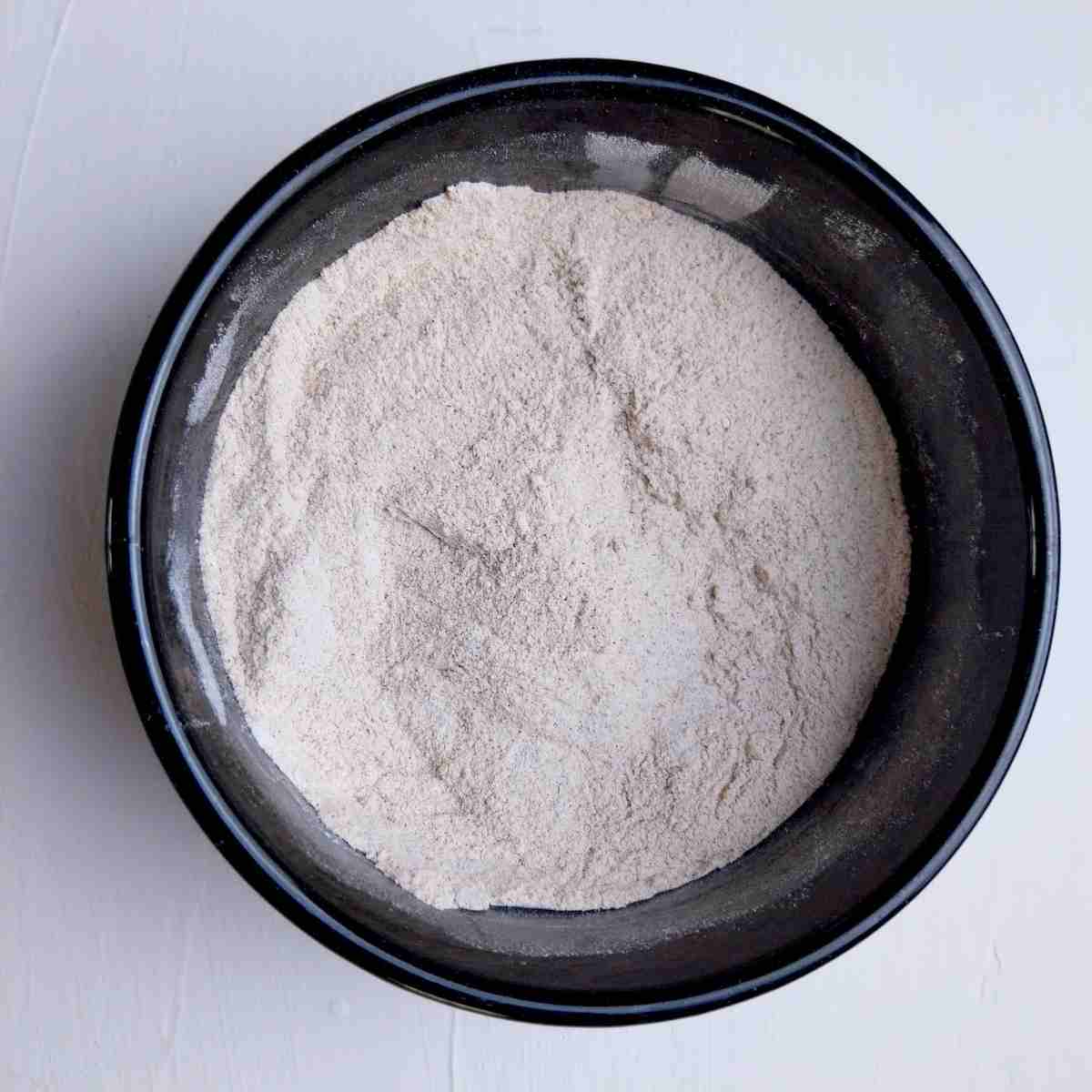 Dry ingredients in a small black bowl.