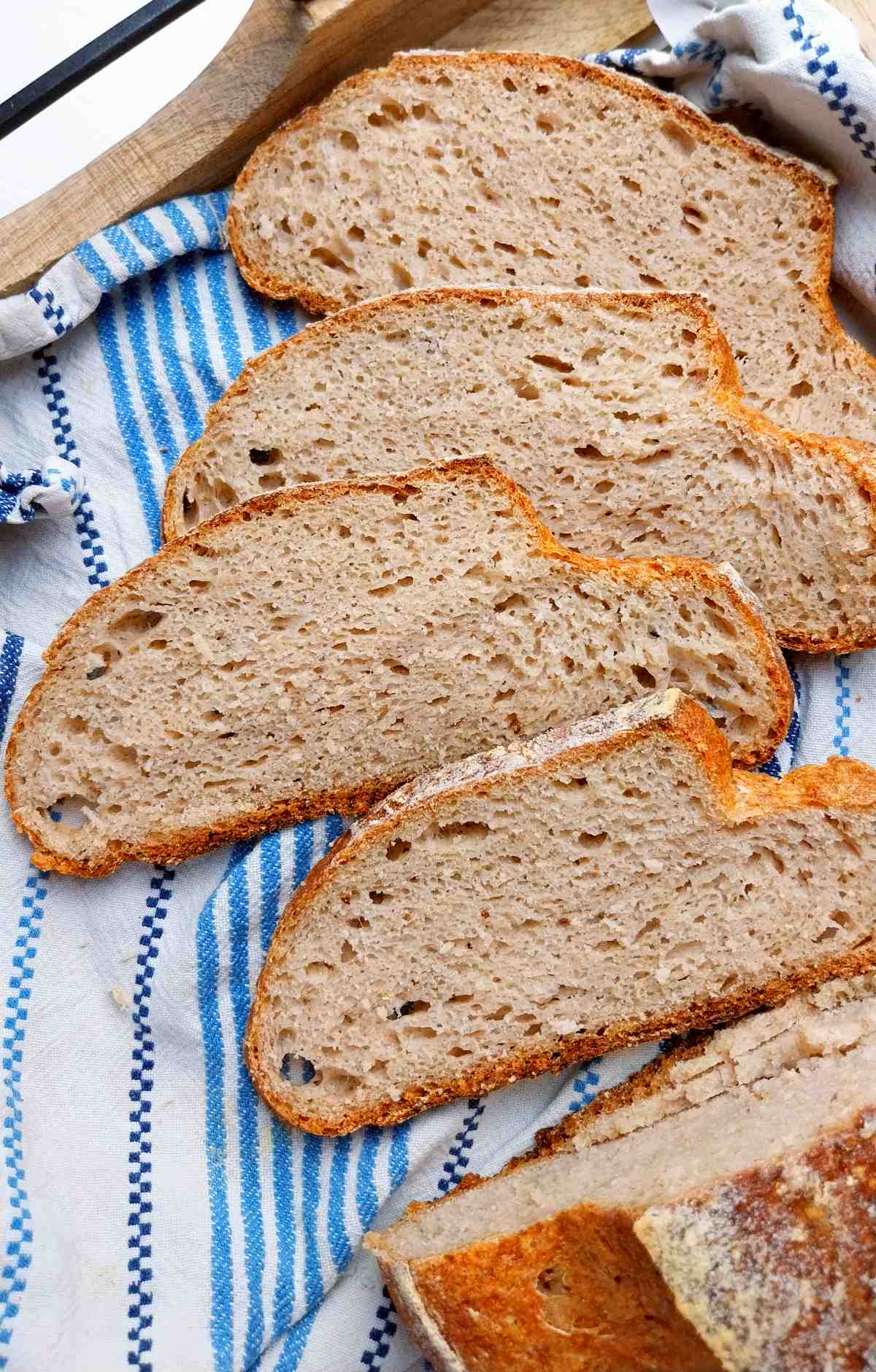 Sliced buckwheat sourdough bread on a kitchen towel.