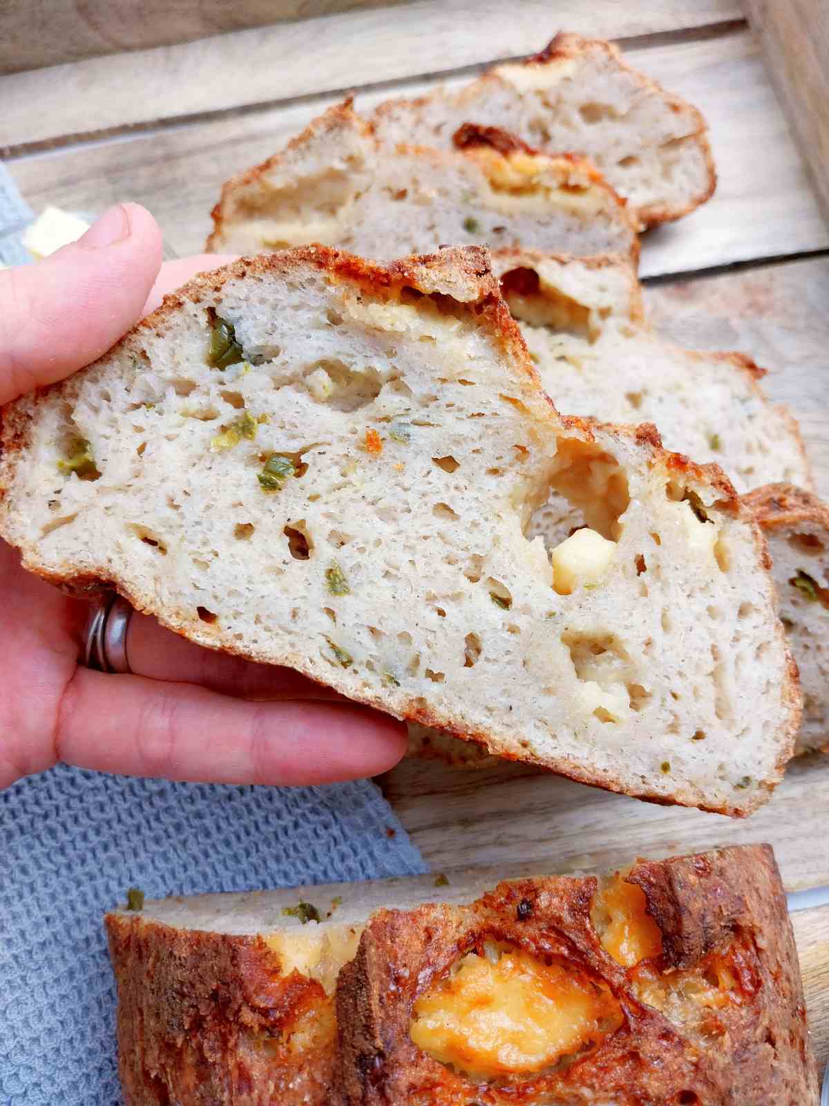 A slice of the cheddar jalapeno sourdough in a hand.