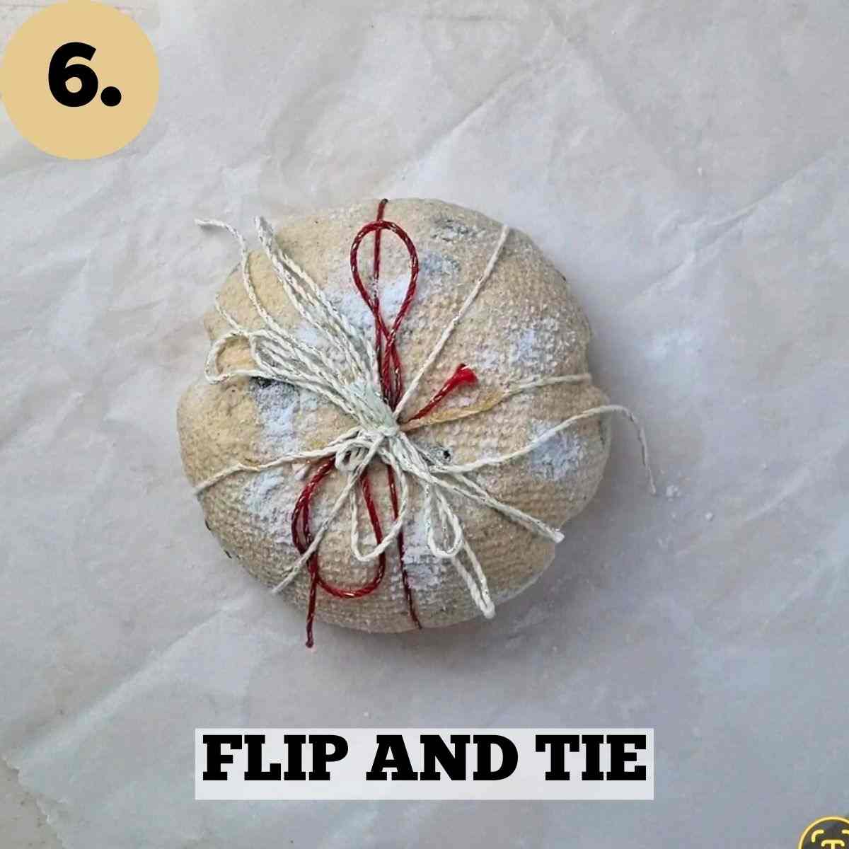 The dough flipped and the threads tied on top.