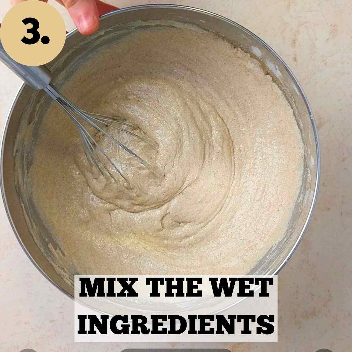 Mixing the wet ingredients with a whisk in a large metal bowl.