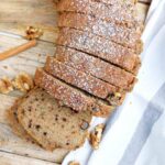 Sliced buckwheat zucchini bread on wooden surface.