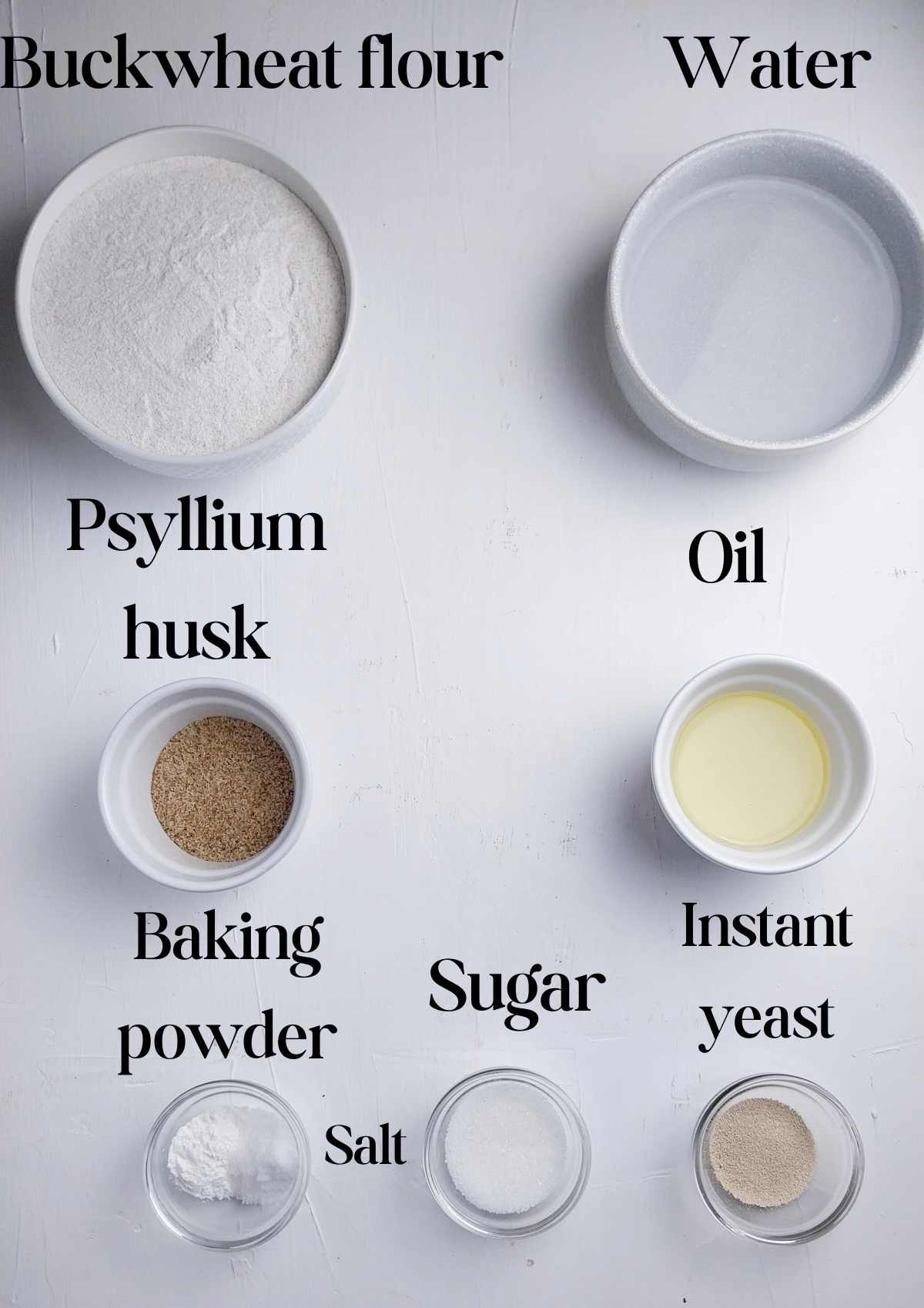 Ingredients for buckwheat bagels on a white surface.
