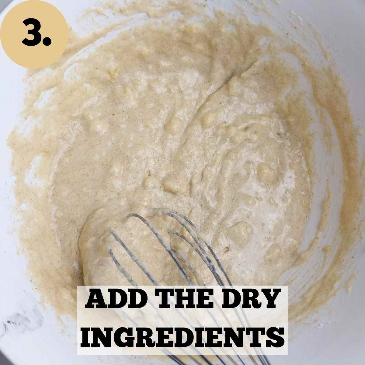 Mixed batter in a bowl with a whisk in it.