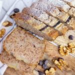 Slices of buckwheat banana bread on a wooden surface.