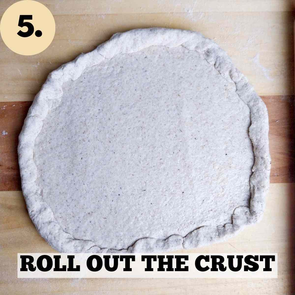 Rolled out dough on the wooden surface.