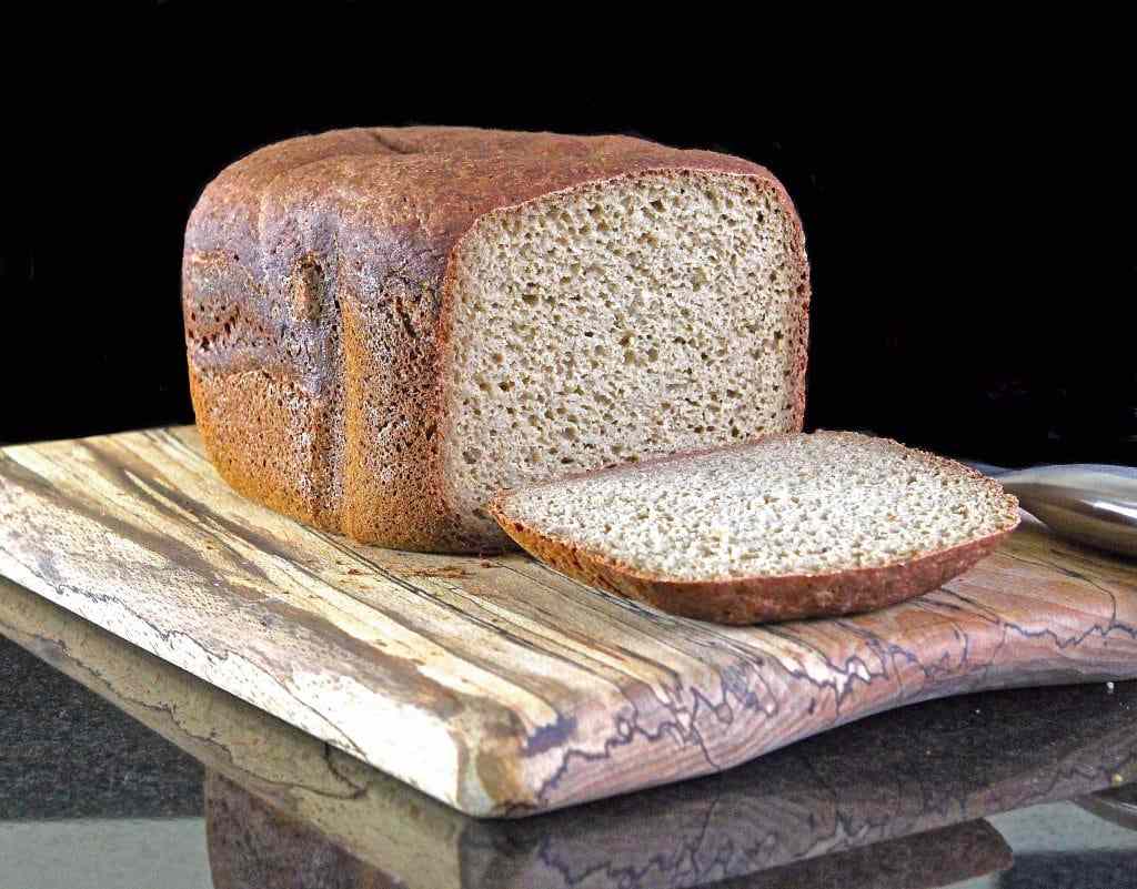A loaf of bread with one slice cut off.