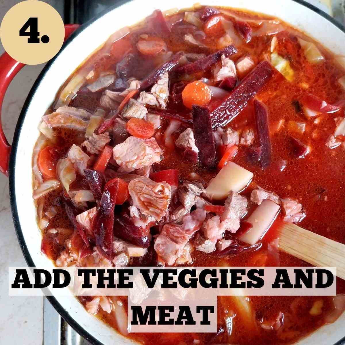 A Dutch oven with the Ukrainian borscht soup in it with a wooden spoon lifting a spoonful of the soup.