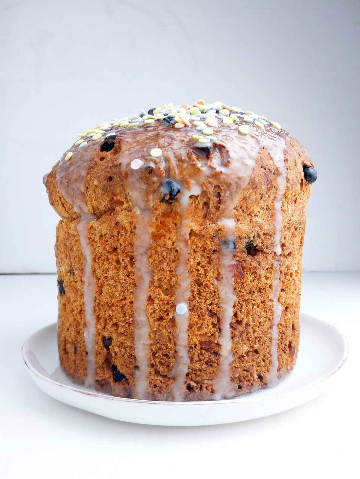 Gluten-free Easter bread on a white plate against a white background.