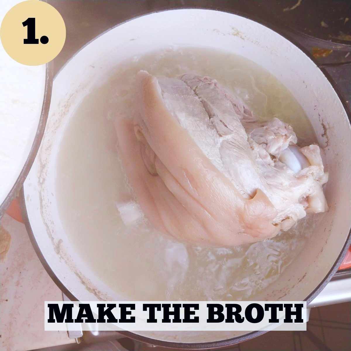A Dutch oven with a large piece of pork in light-colored broth.