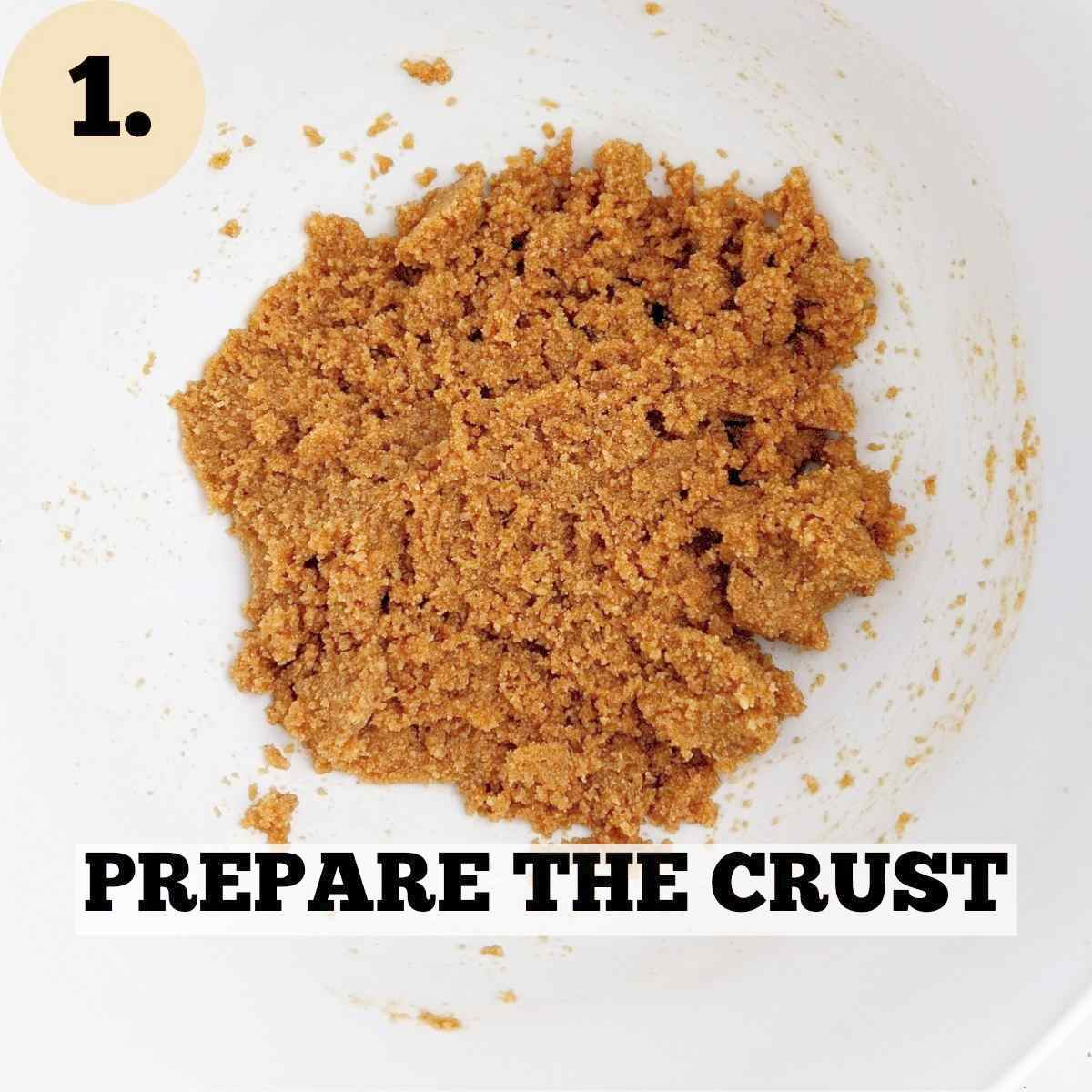 Crushed Graham crackers mixed with melted butter in a white mixing bowl.