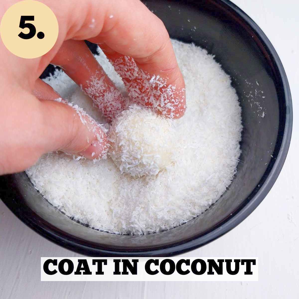Coating the Raffaello balls in desiccated coconut in a black bowl on a white background.