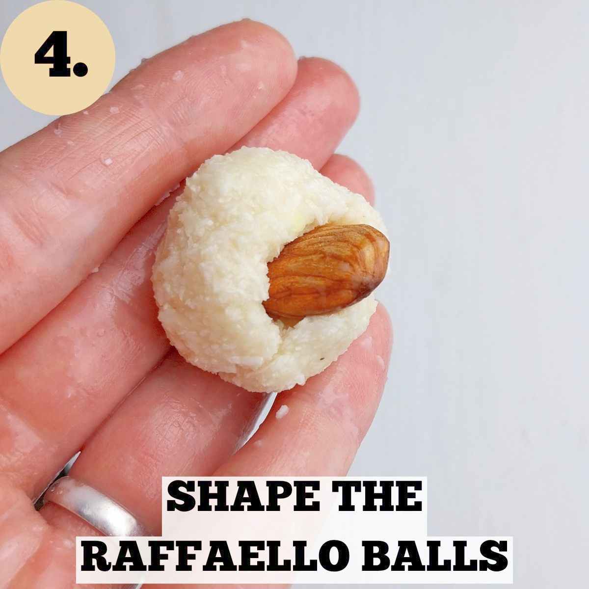 A ball of Raffaello dough with an almond sticking out of it on a white background.