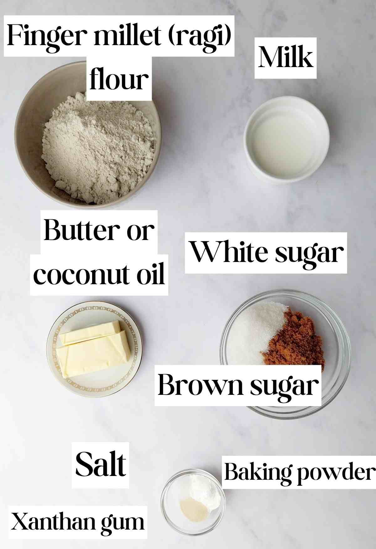 Ingredients for finger millet cookies on a white surface.