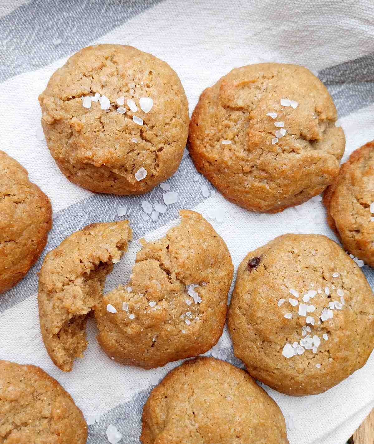 Finger millet cookies on a kitchen towel with flaky salt sprinkled on top.