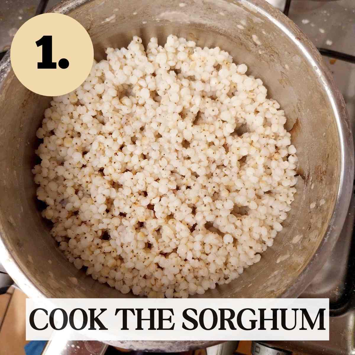 Cooked sorghum grain in a metal saucepan.