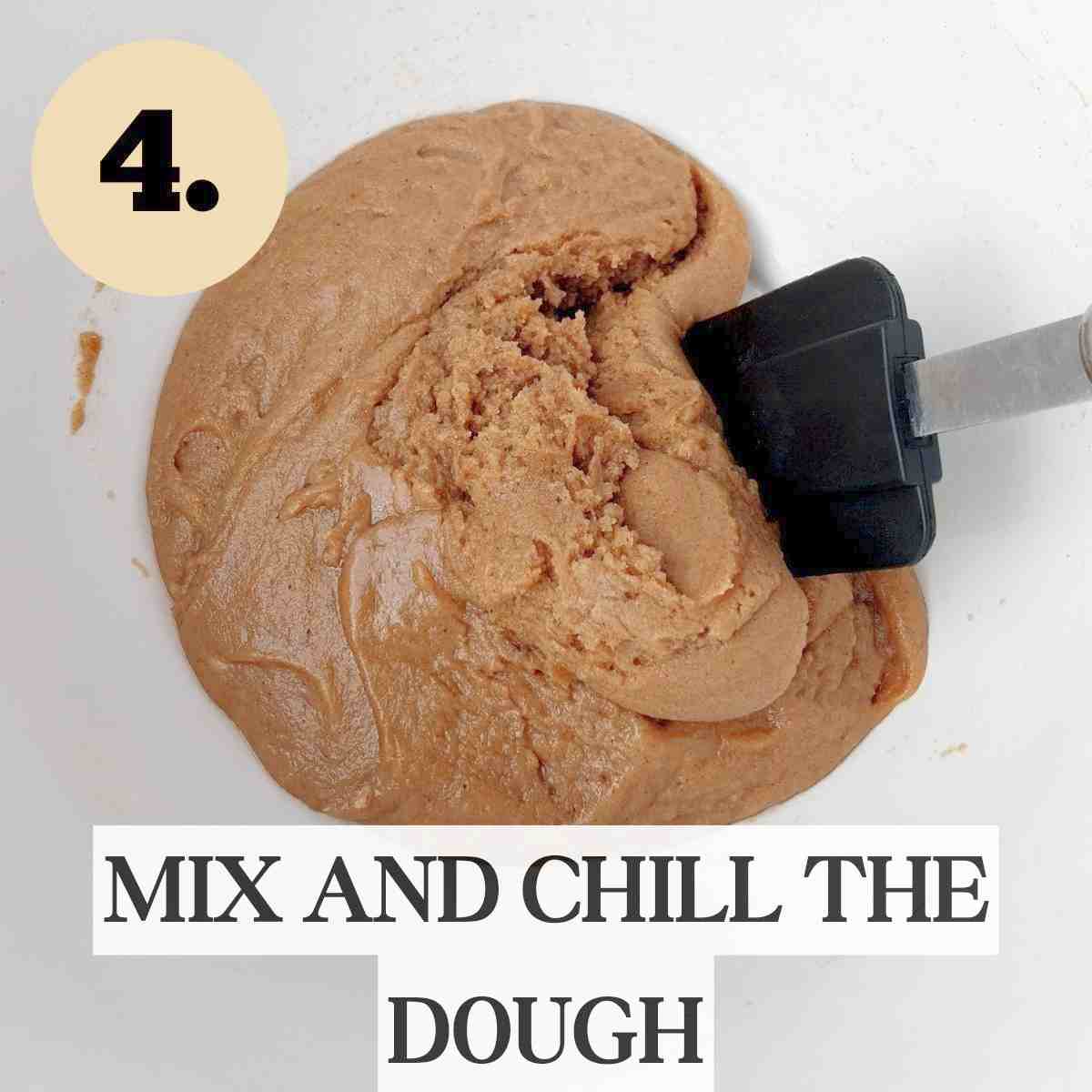 Mixed sorghum dough in a white bowl with a black silicone spatula in it.