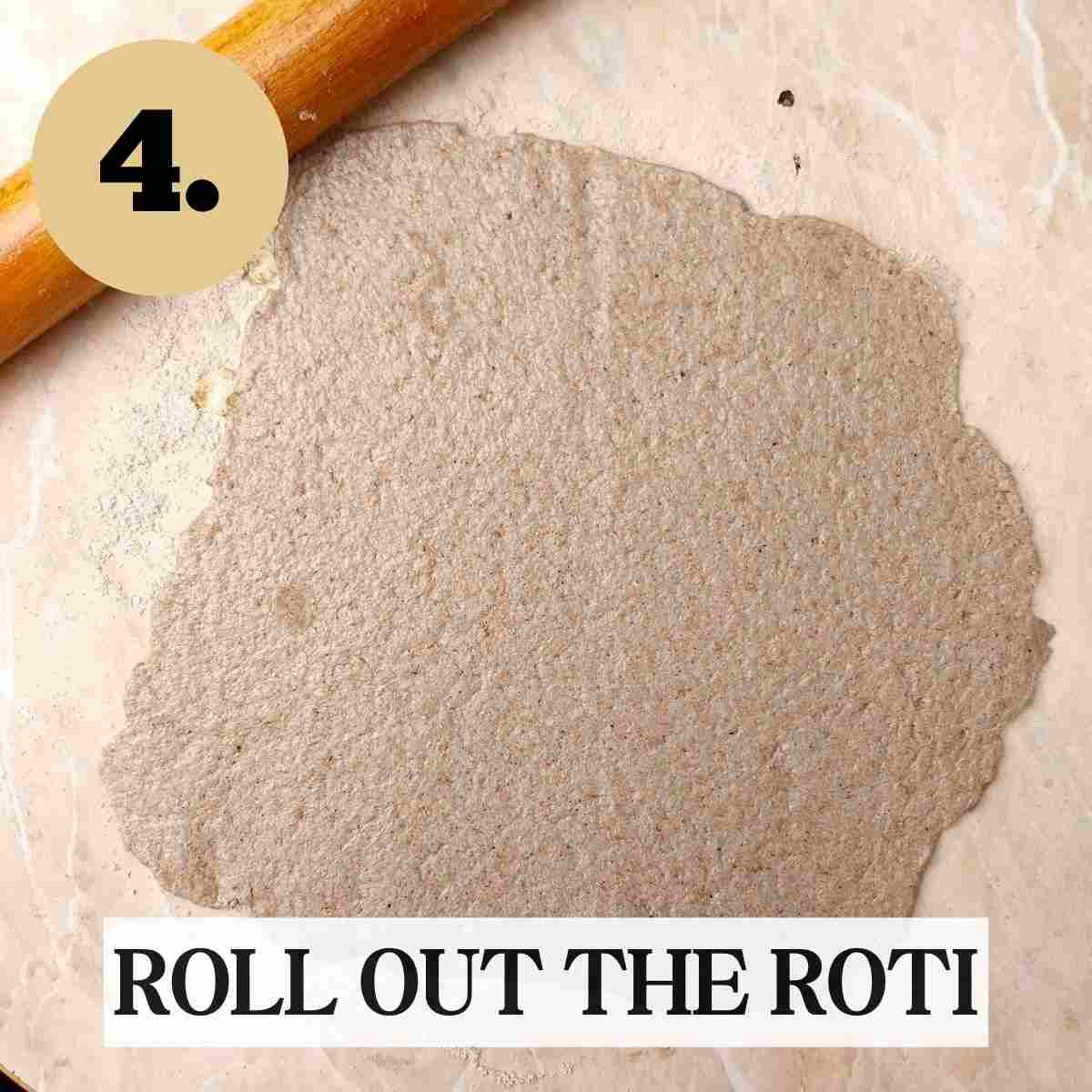 Rolled out ragi flour roti on a light working surface with the wooden rolling pin on the side.